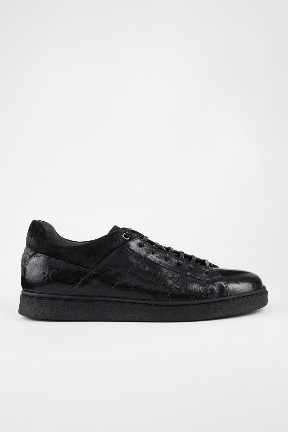 CREED jet-black distressed sneakers.