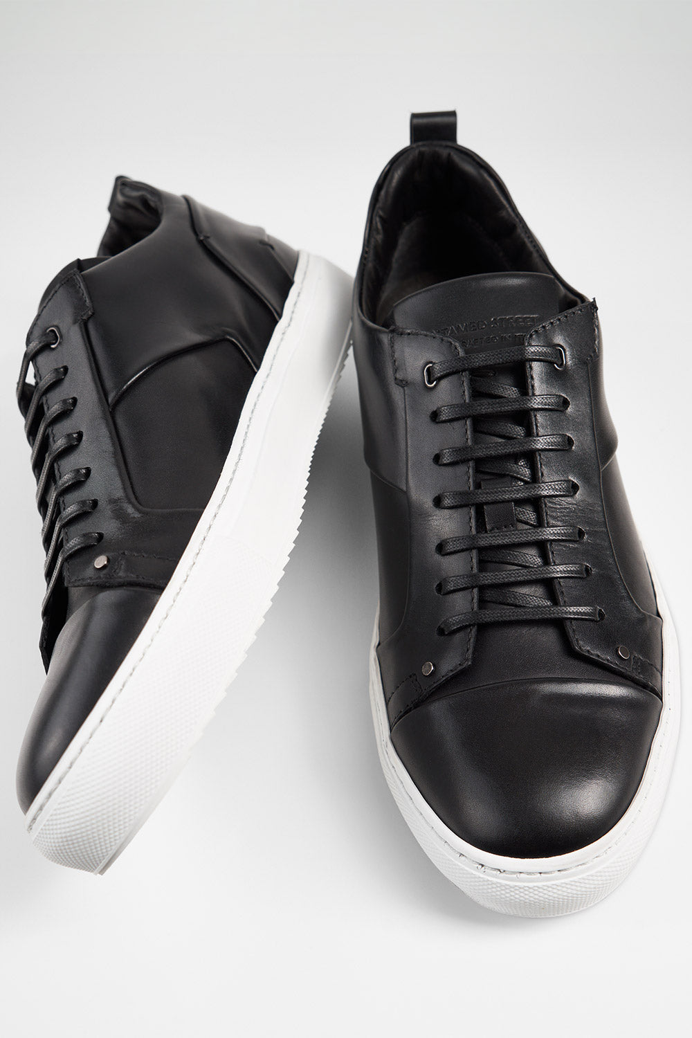 SKYE tuxedo-black studded sneakers.