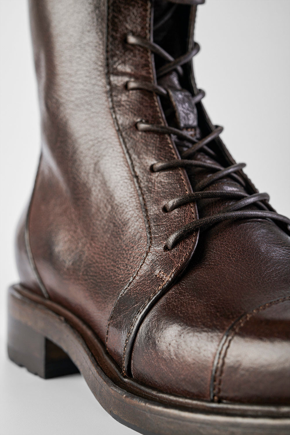 AVERY dark-plum lace-up boots.