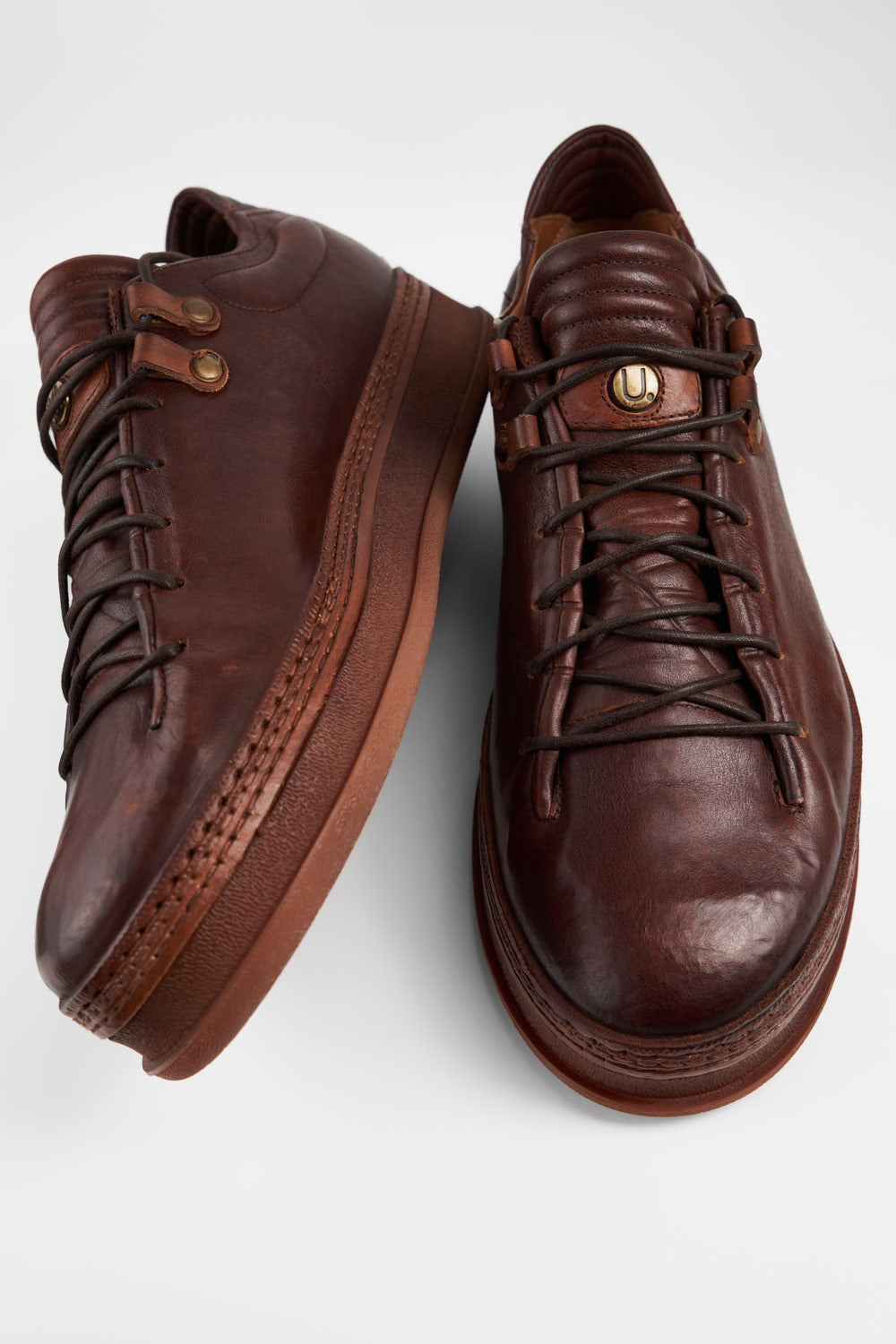 COLE cognac welted distressed loop sneakers.