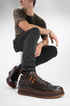 COLE dark-cocoa welted distressed loop sneakers.