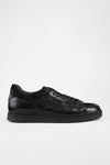 CREED jet-black distressed sneakers.