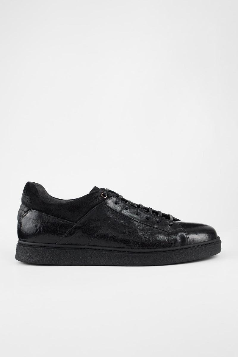 CREED jet-black distressed sneakers.