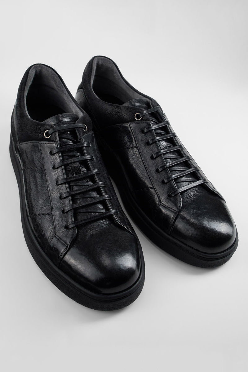 CREED jet-black distressed sneakers.
