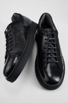 CREED jet-black distressed sneakers.