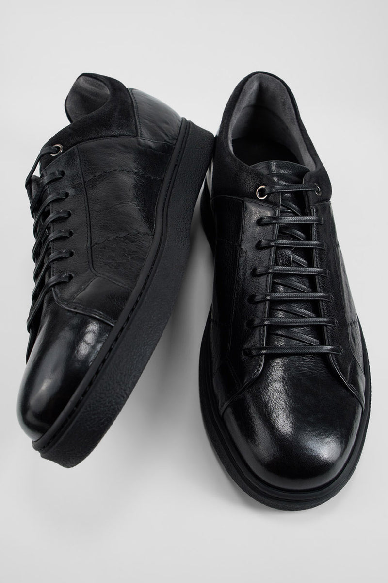 CREED jet-black distressed sneakers.