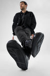 CREED jet-black distressed sneakers.