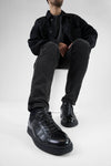 CREED jet-black distressed sneakers.