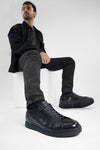 CREED jet-black distressed sneakers.