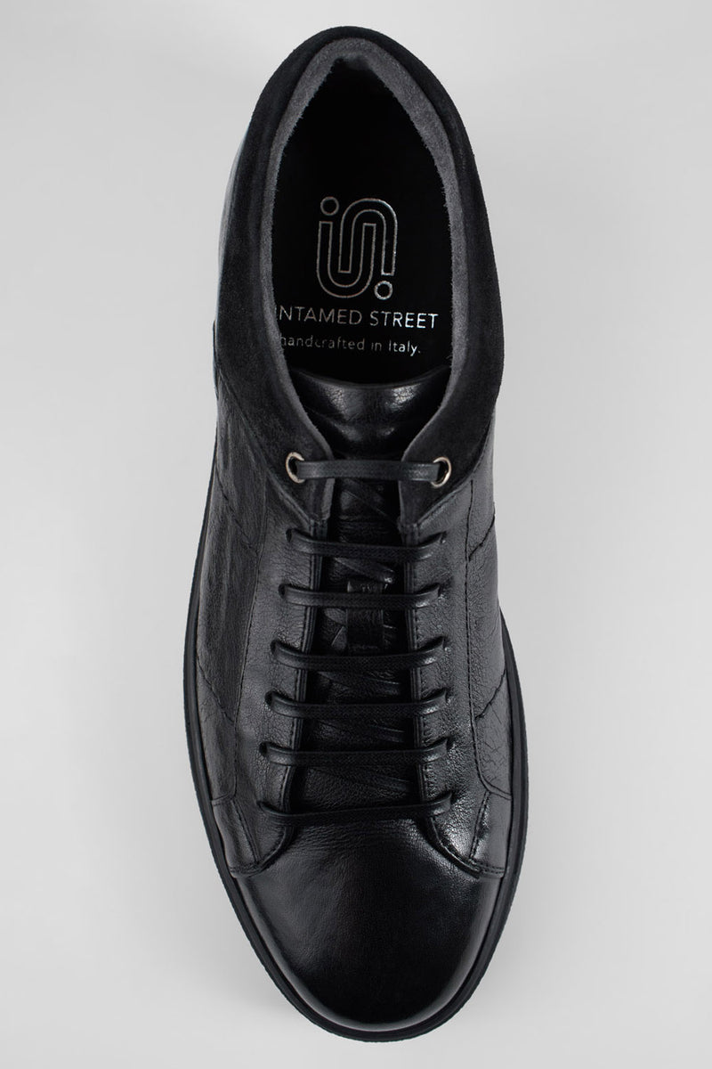 CREED jet-black distressed sneakers.