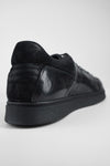 CREED jet-black distressed sneakers.