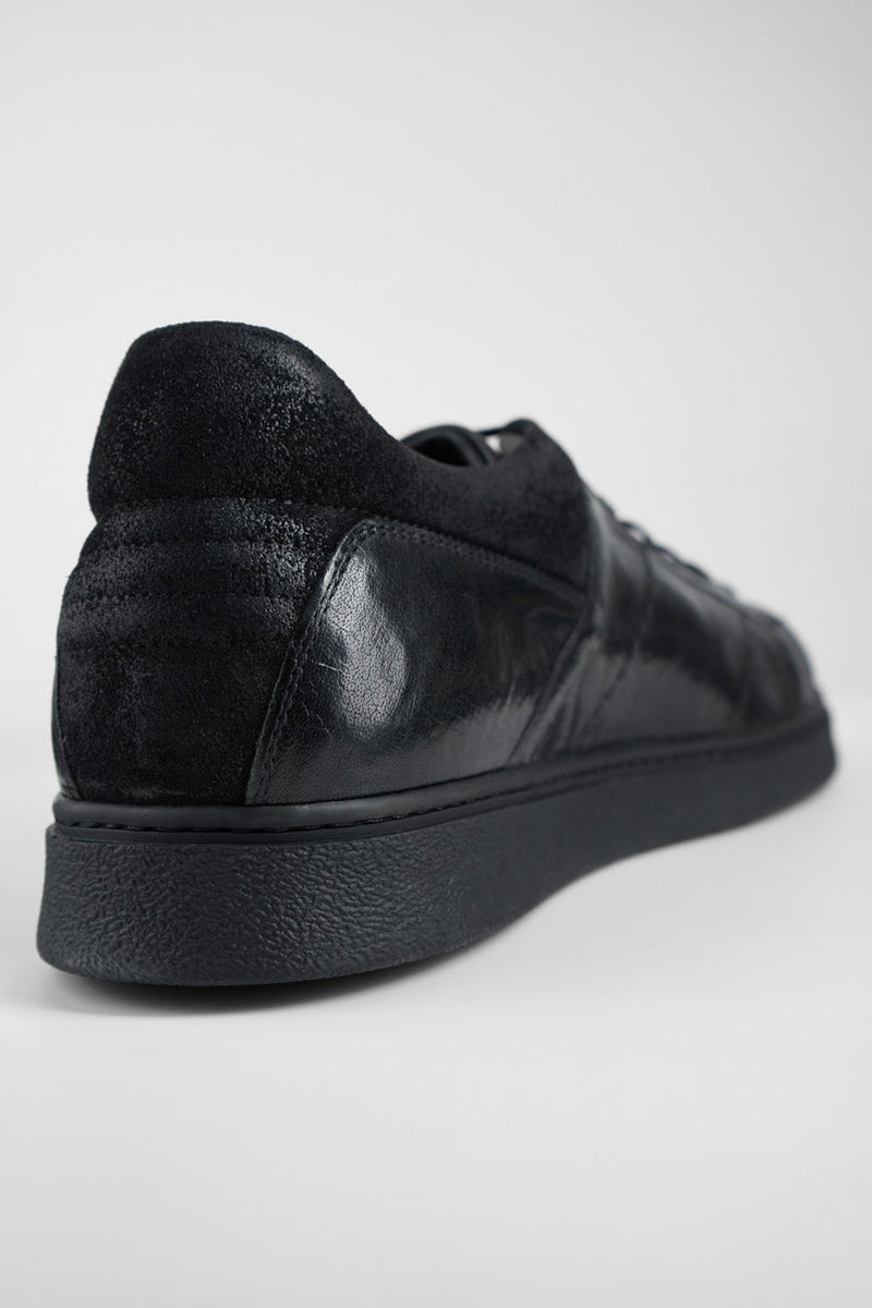 CREED jet-black distressed sneakers.