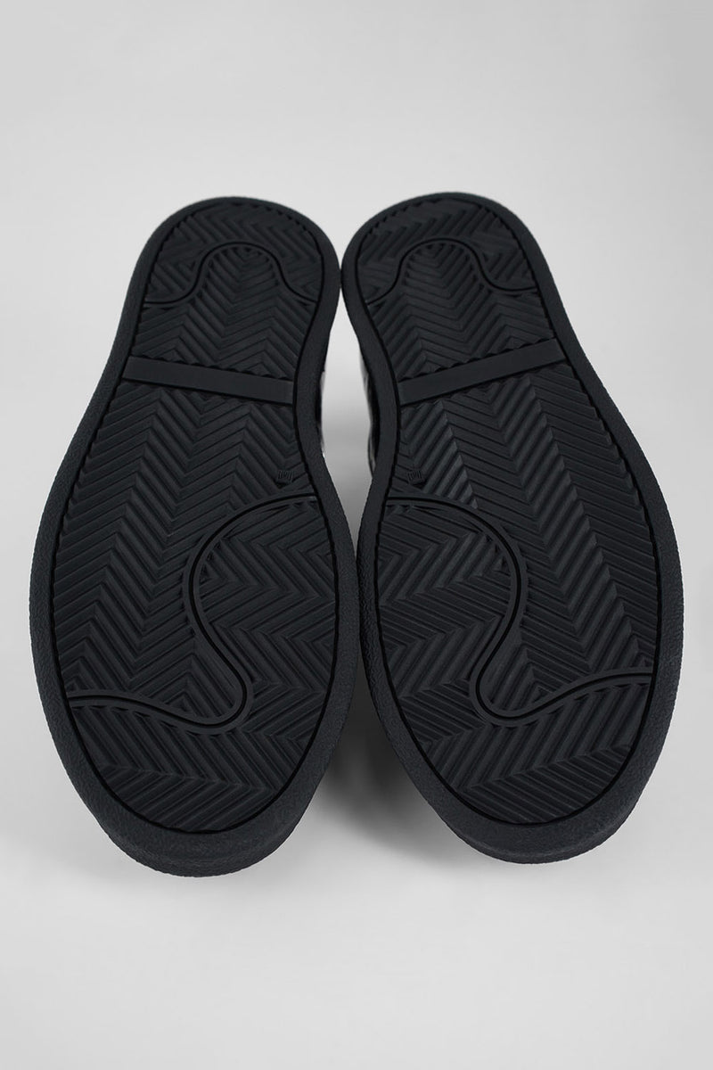 CREED jet-black distressed sneakers.