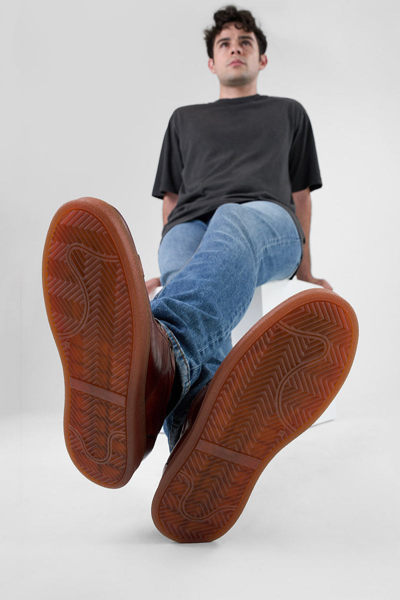 CREED cognac distressed sneakers.