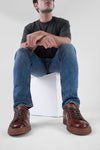 CREED cognac distressed sneakers.