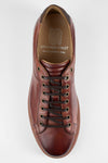 CREED cognac distressed sneakers.