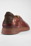 CREED cognac distressed sneakers.