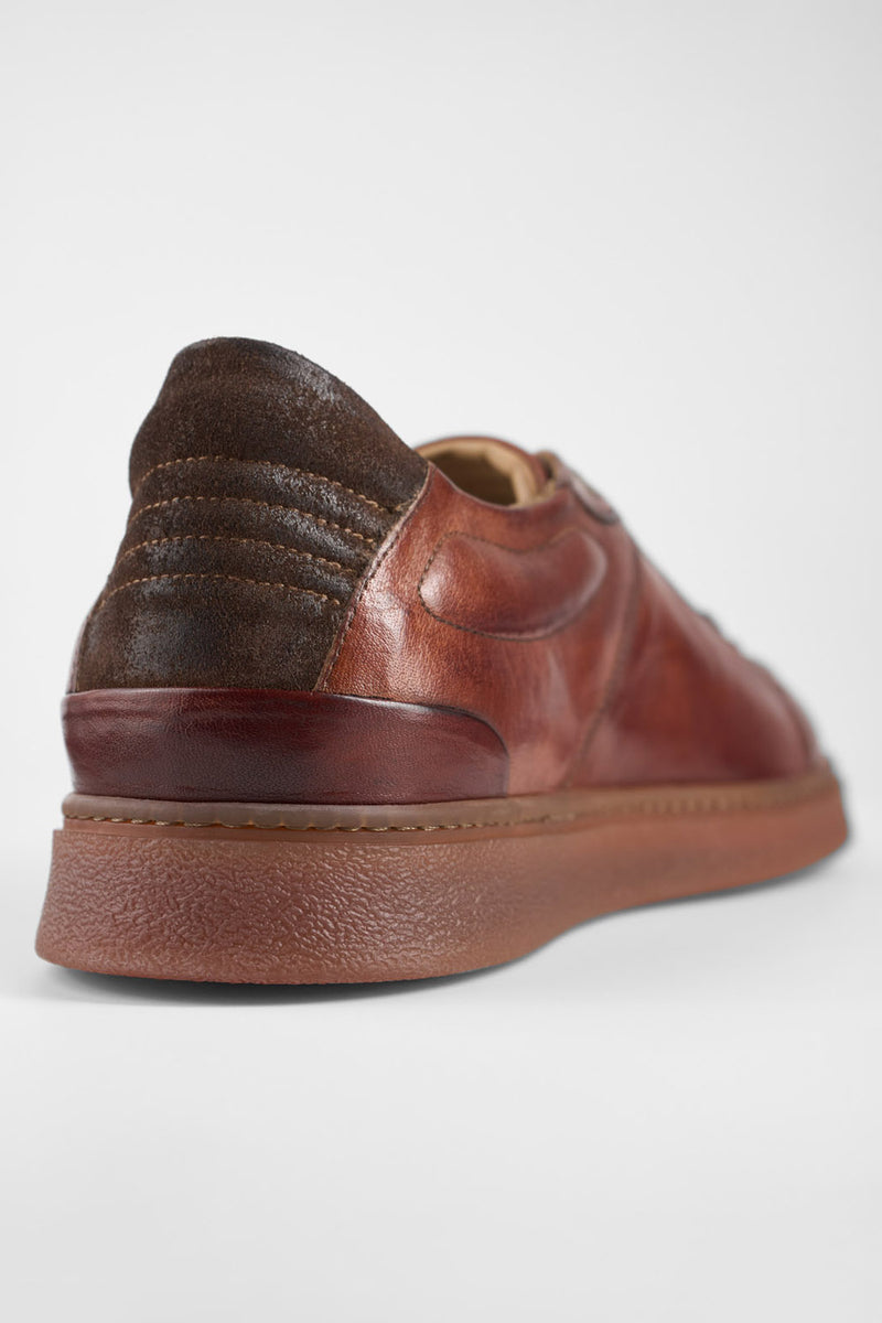 CREED cognac distressed sneakers.
