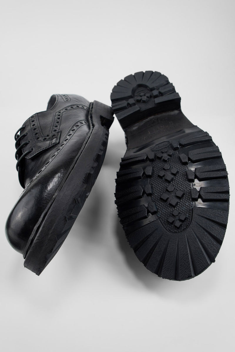 DRAKE jet-black brogue derby shoes.