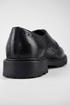 DRAKE jet-black brogue derby shoes.