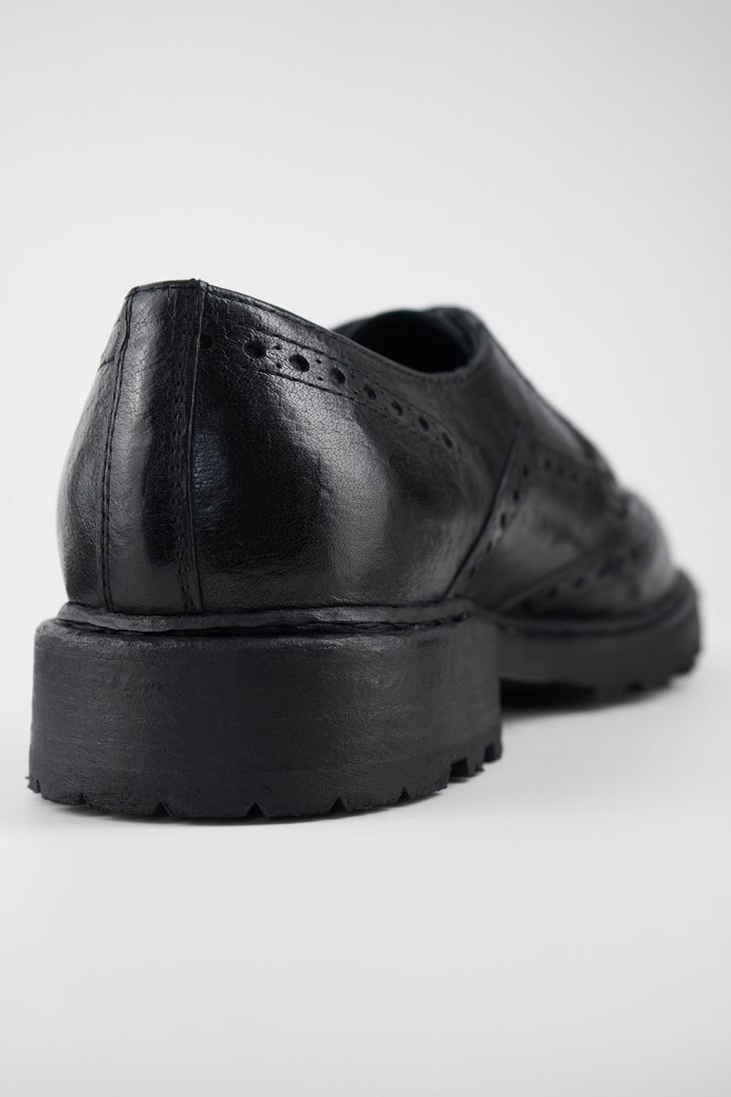 DRAKE jet-black brogue derby shoes.