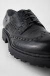 DRAKE jet-black brogue derby shoes.