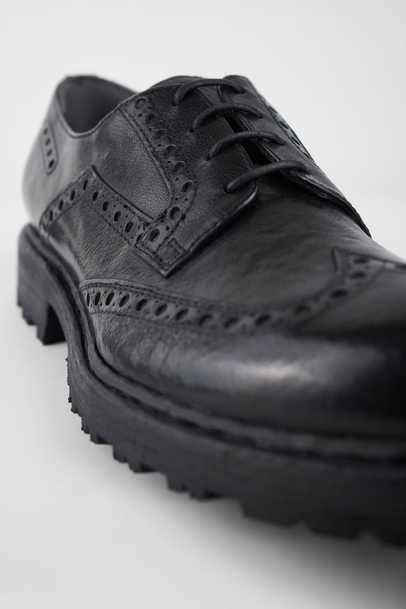 DRAKE jet-black brogue derby shoes.