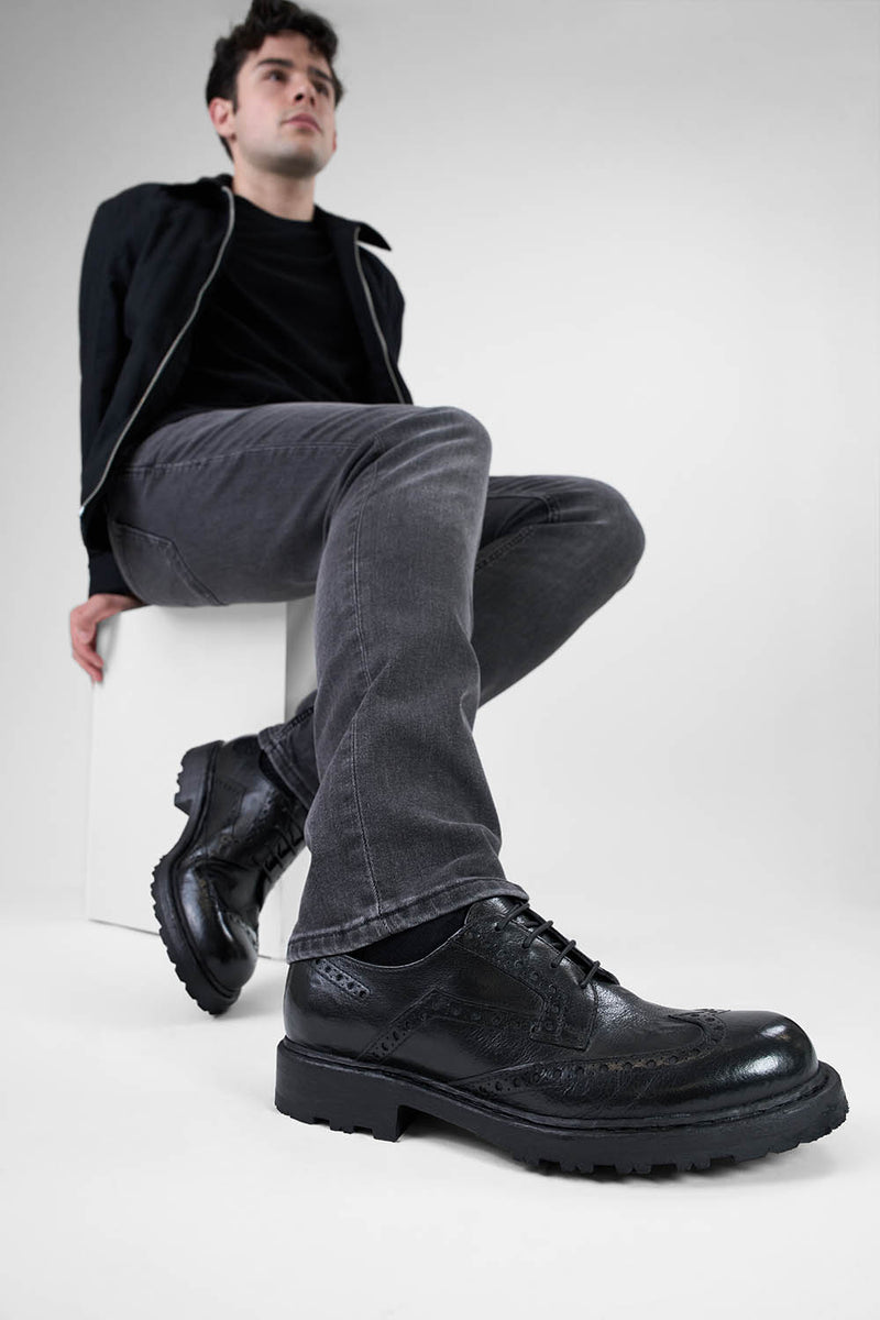 DRAKE jet-black brogue derby shoes.