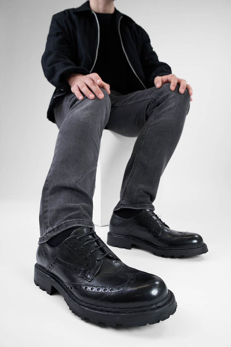 DRAKE jet-black brogue derby shoes.