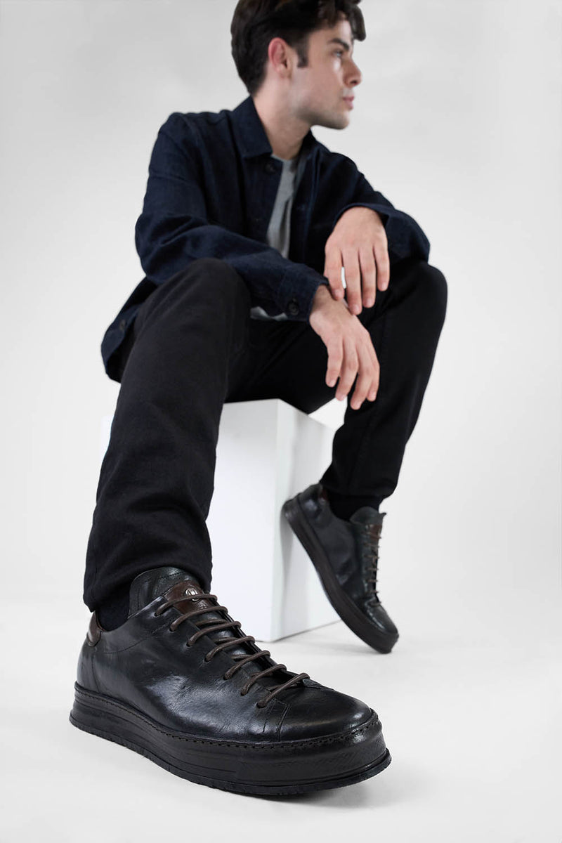 HAYES black distressed welted sneakers.