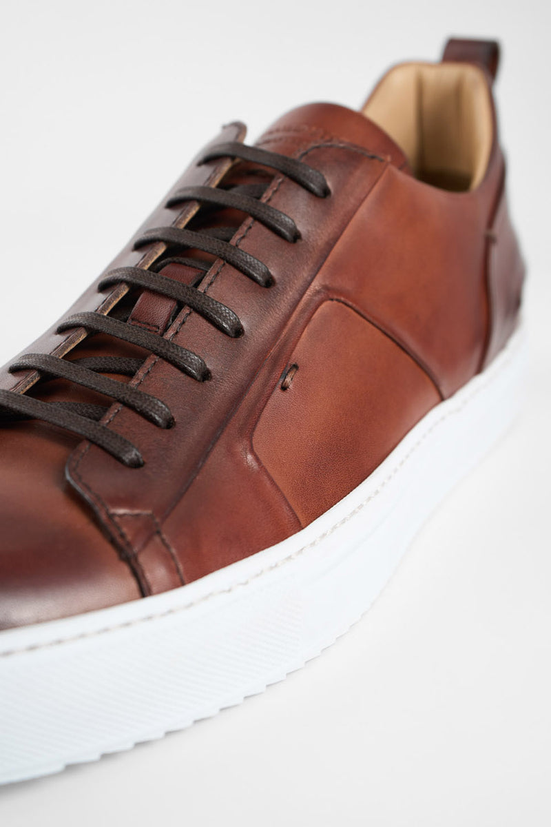 SKYE cognac folded patina sneakers.
