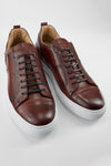 SKYE cognac studded patina sneakers.