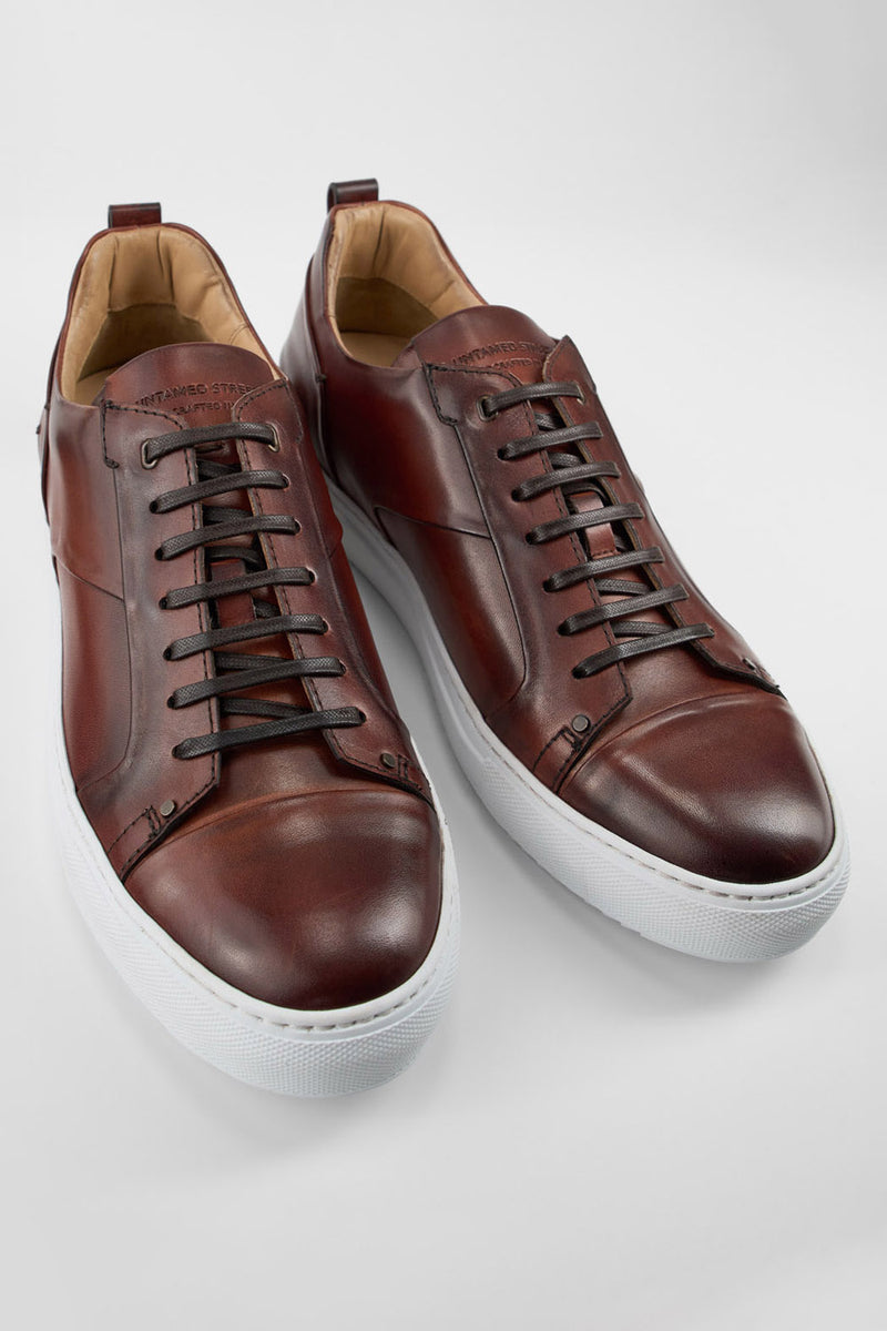 SKYE cognac studded patina sneakers.