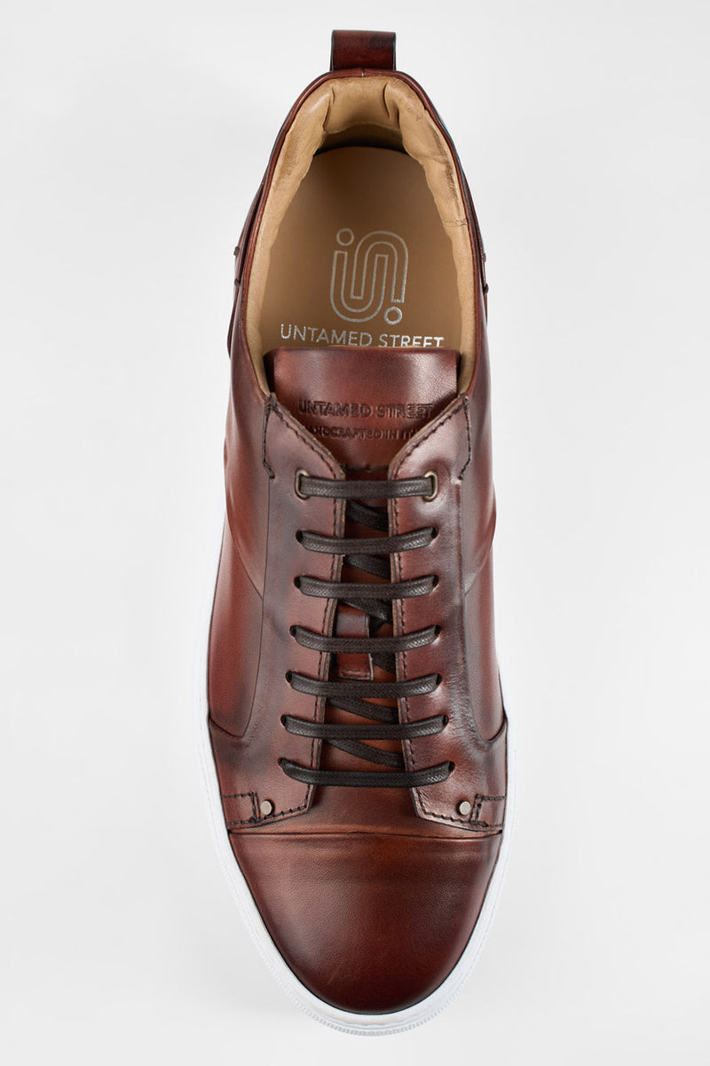 SKYE cognac studded patina sneakers.