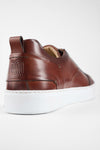 SKYE cognac studded patina sneakers.
