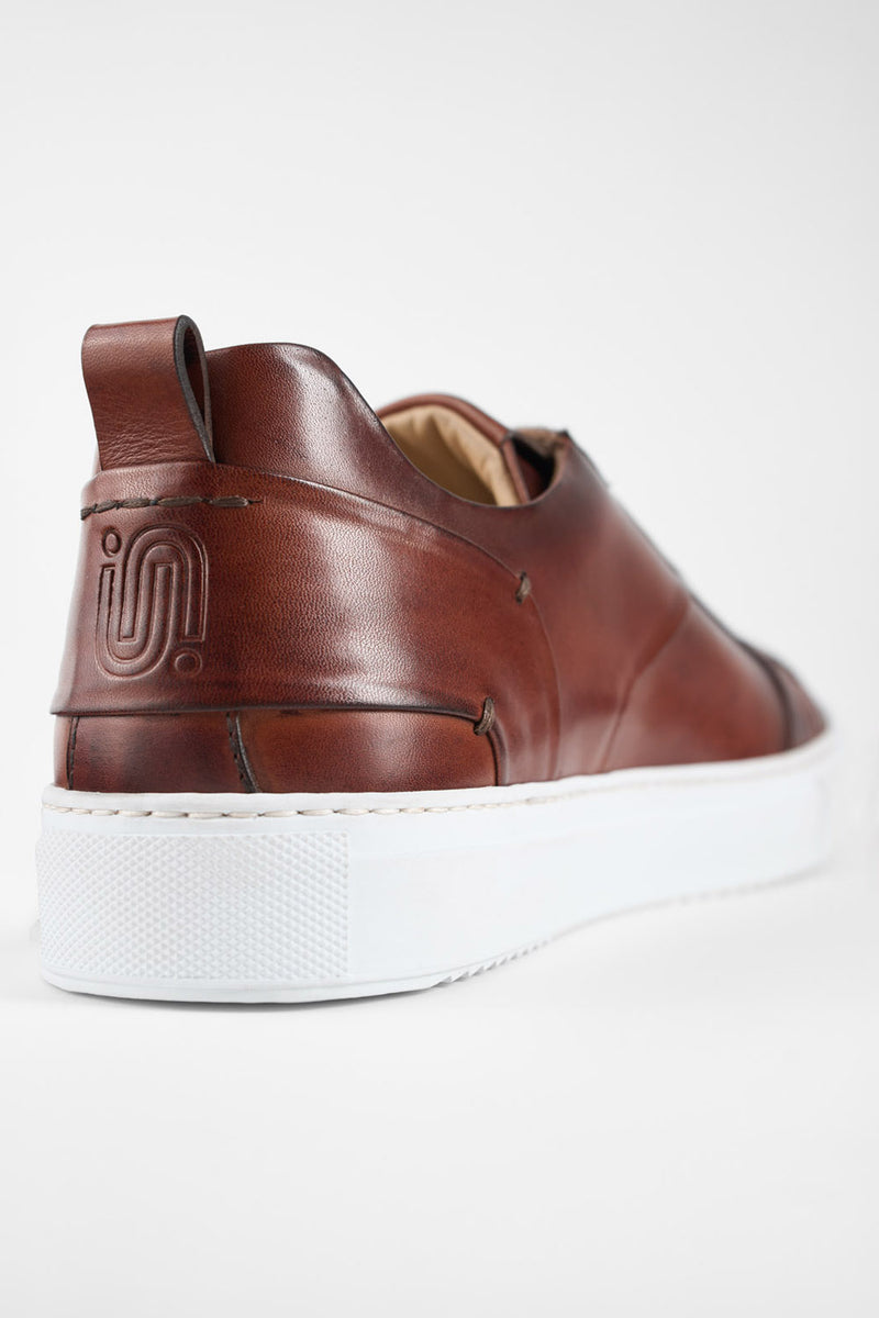 SKYE cognac studded patina sneakers.