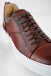 SKYE cognac studded patina sneakers.