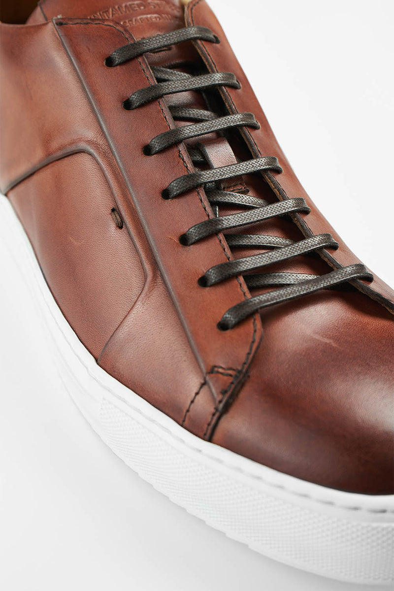 SKYE cognac folded patina sneakers.