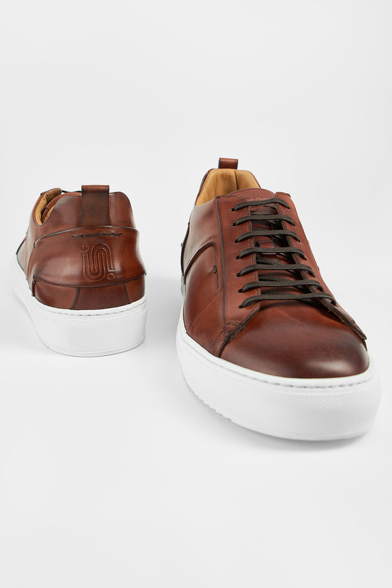 SKYE cognac folded patina sneakers.