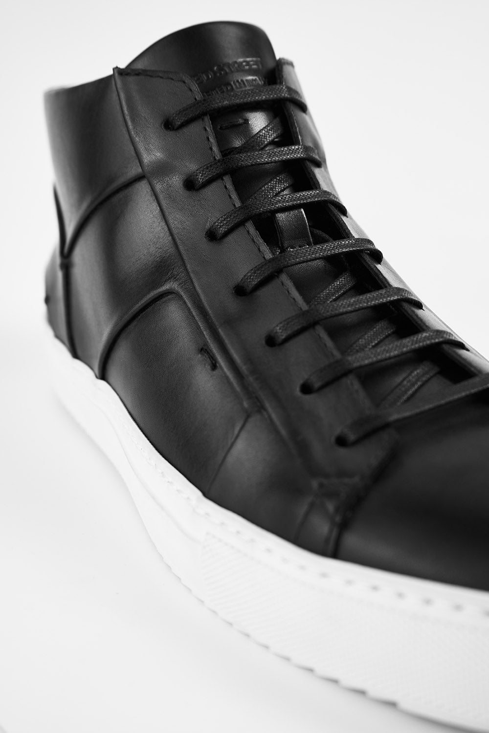 SKYE tuxedo-black folded mid sneakers.