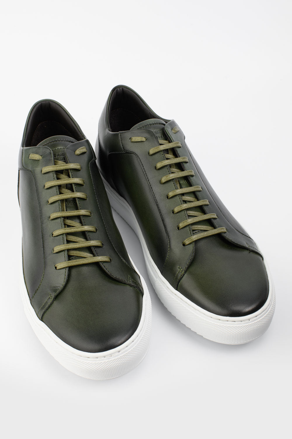 SOHO forest-green patina sneakers.
