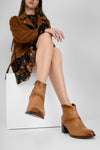 CAROE honey-tan ankle boots.