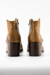 CAROE honey-tan ankle boots.