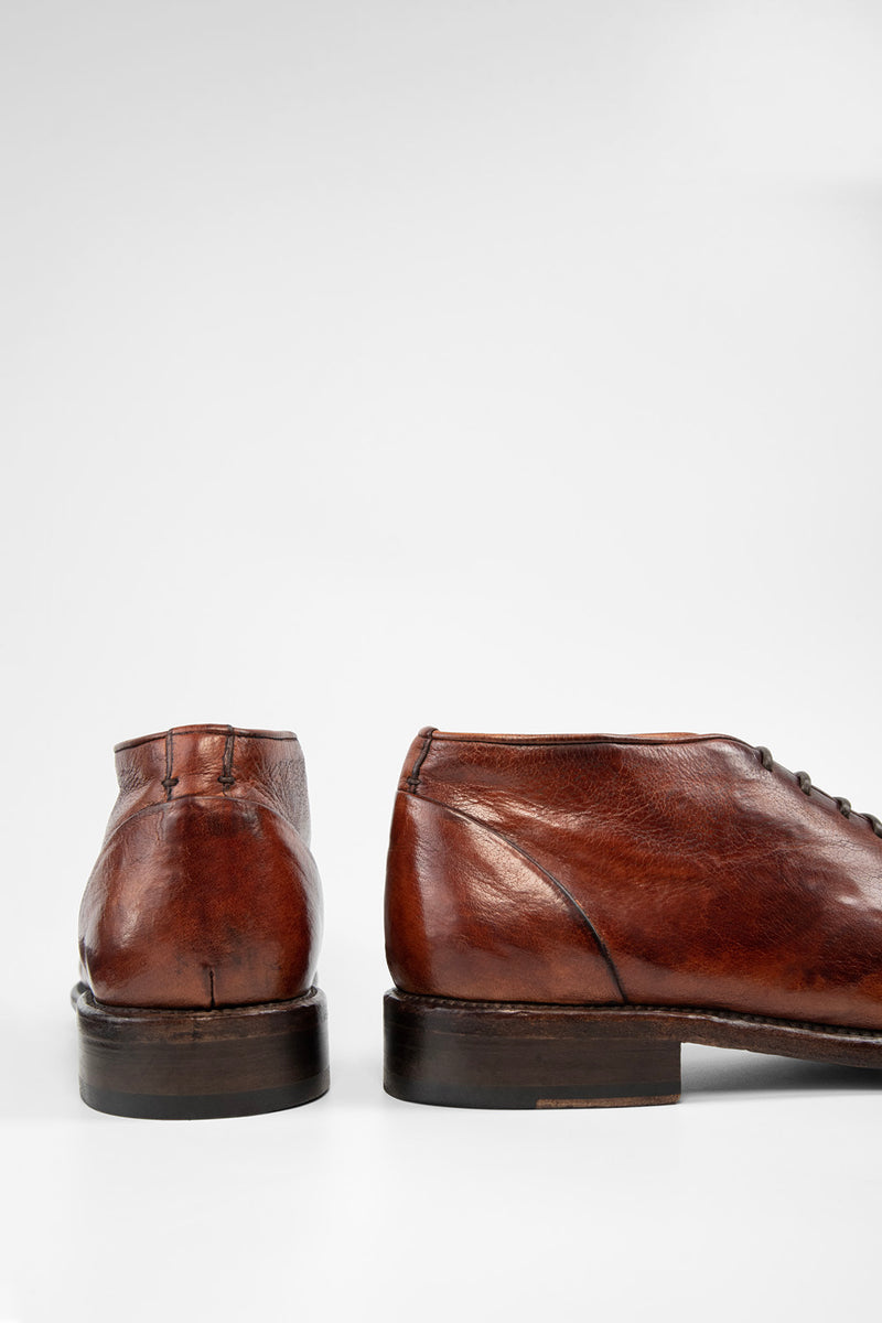 KNIGHTON rich-cognac wholecut chukka boots.