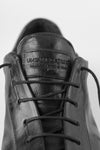 PUTNEY charcoal-black latex sneakers.